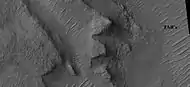 Layers in depression in crater, as seen by HiRISE under HiWish program A special type of sand ripple called Transverse aeolian ridges, TAR's are visible and labeled.