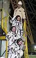 The crew waves to spectators before boarding the rocket.