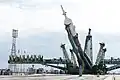 The Soyuz booster is raised into position on the launch pad at Baikonur.