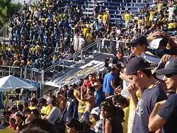 People standing in the bleachers of a stadium