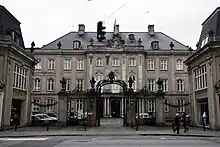 photograph of a large three-story manor house with iron railings