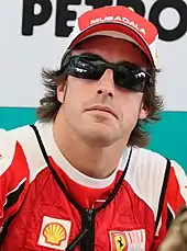 Fernando Alonso wearing a hat and sunglasses