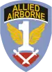 A blue shield with the word "Allied Airborne" on a black background near the top. The centre of the shield contains a white number one with yellow wings. At the bottom, a pair of crossed gladiator swords point down, on a purple-red background.