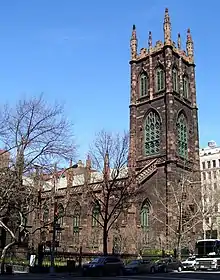 Exterior of Gothic Revival style church with a large tower.