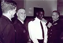 Frocking ceremony for U.S. Navy's first Muslim chaplain, when Navy (rabbi) Chaplain Arnold Resnicoff attaches new shoulder boards with Muslim Chaplain crescent insignia to uniform of Imam Monje Malak Abd al-Muta Noel Jr, 1996.