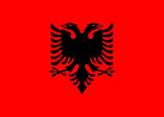 Red flag with a black double-headed eagle in the centre.