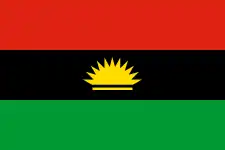 The flag of Biafra, a charged horizontal triband.