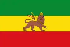 A green, gold, and red vertical tricolor with a lion in the center