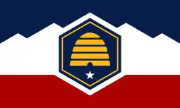 The flag of Utah, a horizontal triband charged with a beehive.