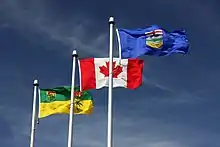 The flag of Saskatchewan flying alongside the flags of Canada and Alberta in Lloydminster