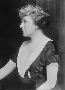 A black-and-white left profile portrait of the upper torso of a woman