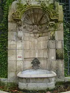 Fontaine de L'Abbaye de Saint-Germain-des-Pres, (1714-1717) built by Victor-Thierry Sully and Jean Beausire, near the church of Saint-Germain-des-Prés. originally at Rue Childebert and Rue Saint-Marguerite.   It was moved in the 19th century to make room for the Boulevard Saint-Germain, and now is in Square Langevin, in the 5th arrondissement, against the wall of the former Ecole Polytechnique.