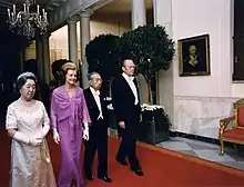 The Fords escort Japanese Emperor Hirohito and Empress Kōjun down the Cross Hall towards the East Room during an October 1975 state dinner honoring the Japanese royals.