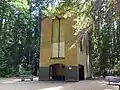 Abandoned brick structure surrounded by forest