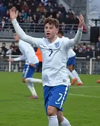 young white man in white and blue kit