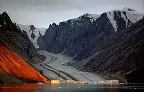 Franz Josef Fjord, glacier. The orange colour is caused by reflected sunlight.