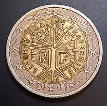 French 2 Euro coin 2011. The design features a tree symbolising life, continuity and growth, standing within a hexagon and encircled by the motto of the French Republic, "Liberté, Egalité, Fraternité" (Liberty, equality, fraternity)