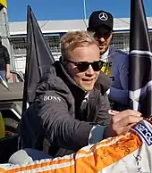 Felix Rosenqvist signing autographs for fans at a motor racing event