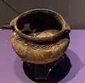 A small pot with guilloché designs