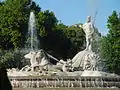 Fountain with statue of Neptune atop a two-horse shell chariot with a water wheel