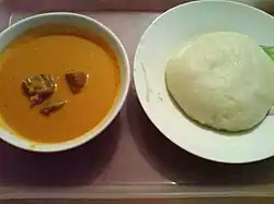 A plate of fufu (right) accompanied by peanut soup