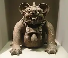 A funerary urn in the shape of a "bat god" or a jaguar, from Oaxaca, Mexico, dated to 300–650 CE.  Height: 9.5 in (23 cm).