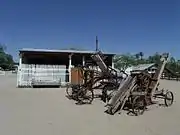 Farm machinery and 1890s Horse Stable (in background).