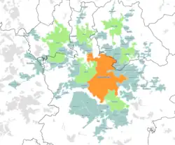 A map of the Greater Manchester Built-up Area according to the 2011 census, with Travel to Work Areas overlaid.  Manchester is highlighted in orange