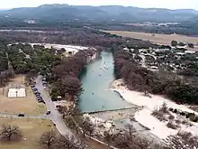 The Frio River winds along the east side of Garner State Park (on the left, showing a dam that forms a swimming area).