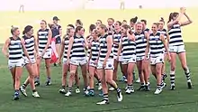 Group of female athletes walk from football oval after a game