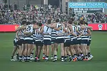 Team huddle on surface of playing arena