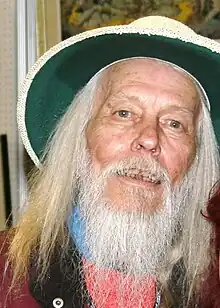 A man with a white beard and a hat.