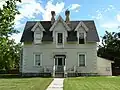 George M. Brown House, built in the 1880s, uses bilateral triparte symmetry in its facade. The decorations are in the Gothic revival style.