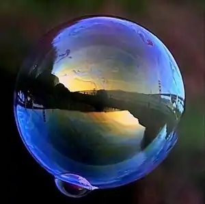 A soap bubble balances surface tension forces against internal pneumatic pressure.