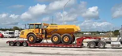 A lowboy trailer carrying a truck