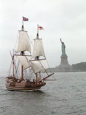 A replica of the early 17th century Godspeed flying the flags of Great Britain and the Kingdom of England