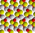 The goethite crystal structure viewed along [001]. Red ions are iron, white are oxygen, and yellow are hydroxide.