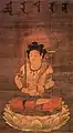 A japanese painting of Manjushri (monju) holding a sword and a lotus topped with a sutra, Kamakura period