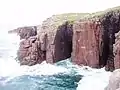 The popular Twin Cave area of the Gola sea-cliffs, on a windy day. Twin Cave Buttress, on the right, is about 20 metres (66 feet) high and contains six climbs with grades S/4a to E3/6a.