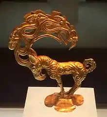 Gold stag with eagle's head, and ten further heads in the antlers. An object inspired by the art of the Siberian Altai mountain, possibly Pazyryk, unearthed at the site of Nalinggaotu, Shenmu County, near Xi'an, China. Possibly from the "Hun people who lived in the prairie in Northern China". Dated to the 4th-3rd century BCE, or Han dynasty period. Shaanxi History Museum.