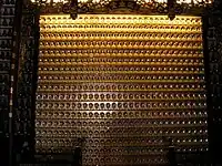 Wall with some of the smaller Buddha statues inside the temple