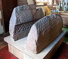 The two hogsback tomb markers now in the parish church, thought to be stylised "houses of the dead" with tiled roofs.