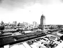 View toward the southeast of the city center, with the FEC passenger trains and the Dade County Courthouse foreground, circa 1930s