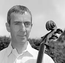 portrait of Graham Waterhouse, holding a cello