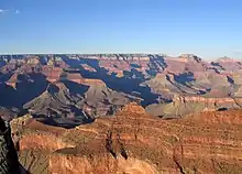 O'Neill Butte, (above Supai Group 'redbeds'), on ridgeline from Yaki Point; (Newton Butte prominence off photo, right)View northeast, with Cape Royal (point) on Walhalla Plateau (Kaibab Plateau), and flat-top of Wotans Throne and Vishnu Temple prominence. (from Yavapai Point, west of Yaki Point, South Rim)