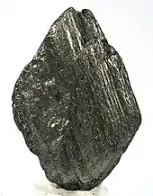 A black multi-layered lozenge-shaped rock