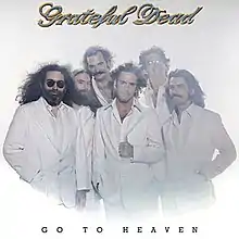 The Grateful Dead standing in white suits