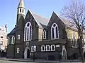 The former St Barnabas Church, Kentish Town Road, Camden in London, 1884–85 by Ewan Christian, now the Greek Orthodox Cathedral of St Andrew, showing the west front with north apse and turret