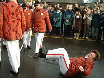 Boxing Day 2004 - The Grenoside Sword Dance Captain is ritually "beheaded" as the dancers withdraw their swords sharply from around his neck