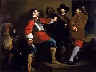 In a stone-walled room, several armed men physically restrain another man, who is drawing his sword.